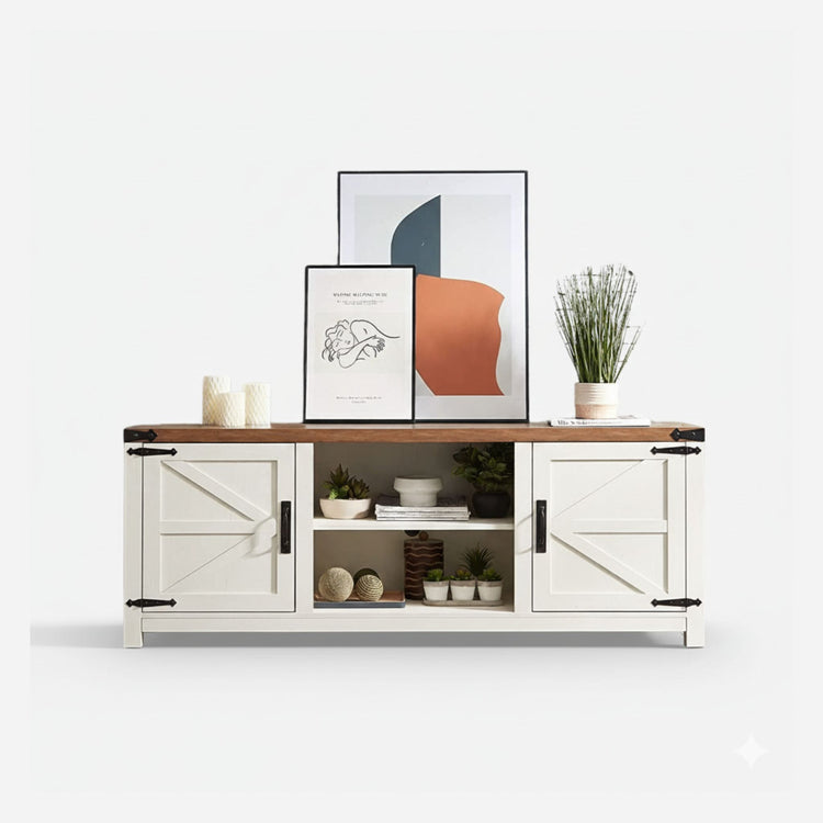 White sideboard with wooden top, framed art, candles, and plants on a white background