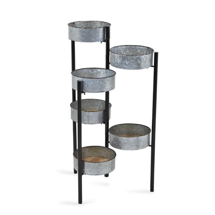 Black metal plant stand with galvanized pots on a white background