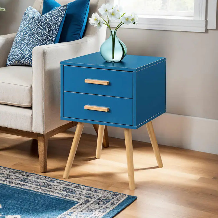 Blue finish end table with two drawers and light wood legs beside a sofa, mid-century modern accent.