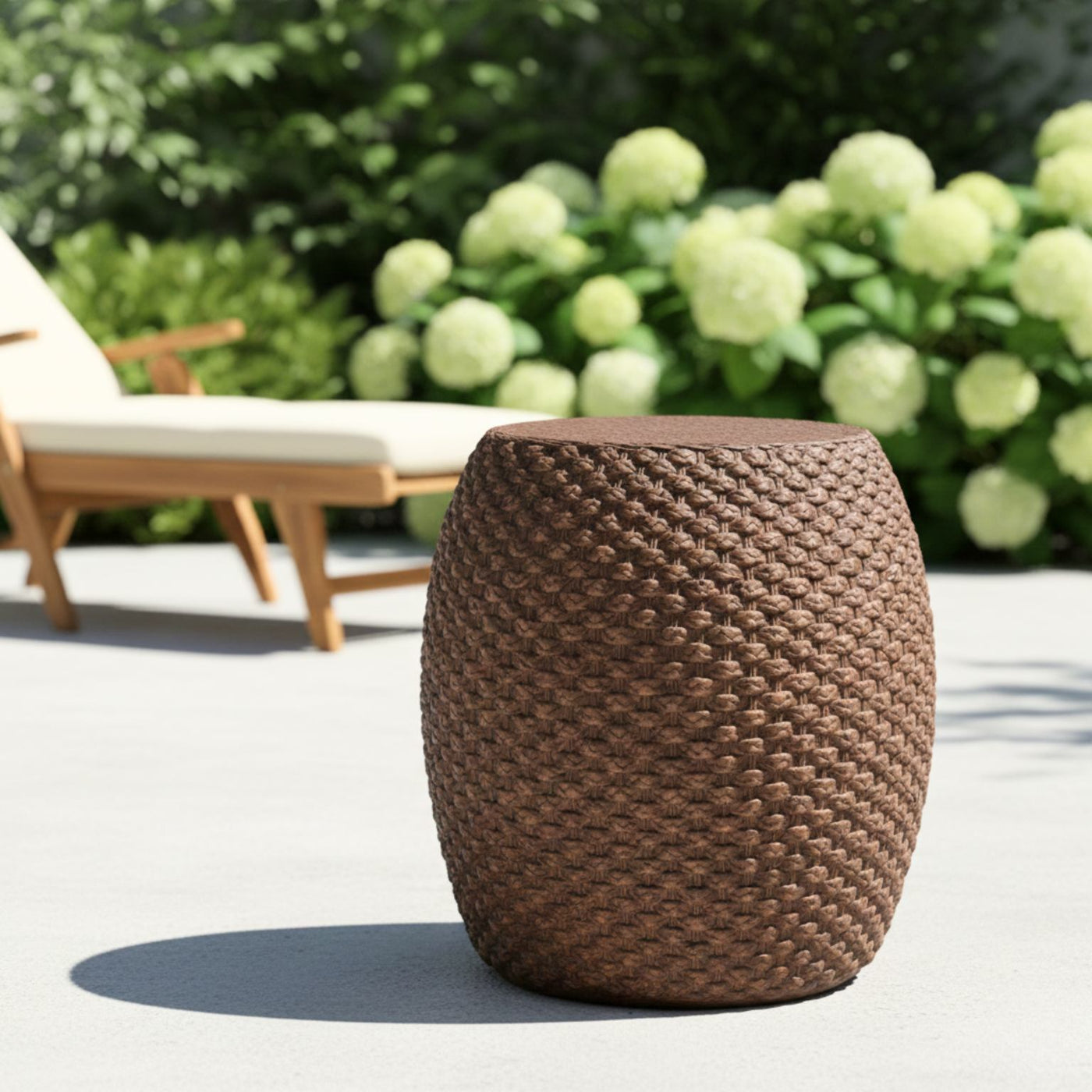 Brown faux rattan side table for indoor/outdoor use with woven texture.