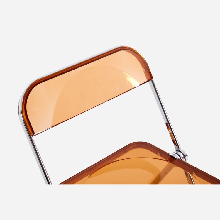 Clear chair with yellow transparent backrest and seat on a white background