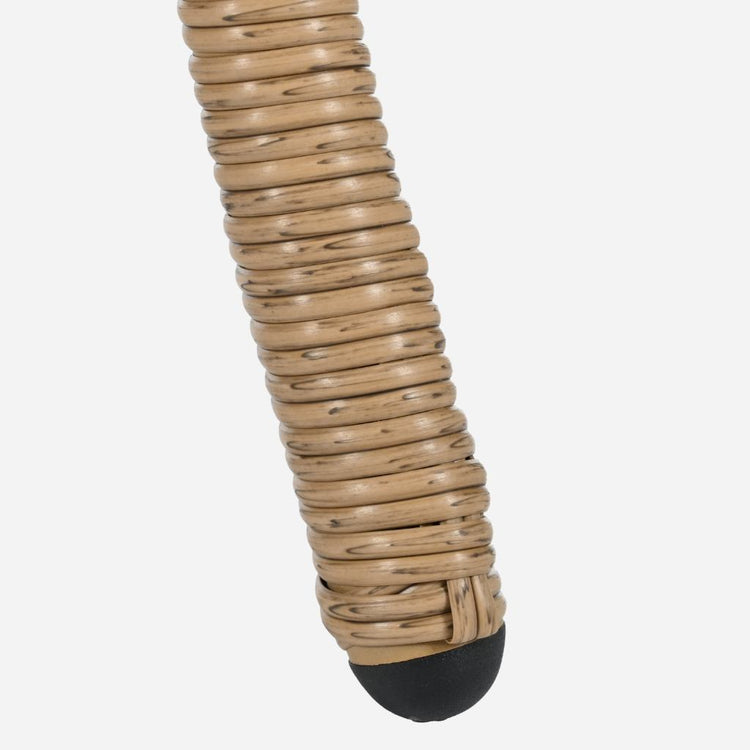 Close-up of a beige woven object with a black base on a white background