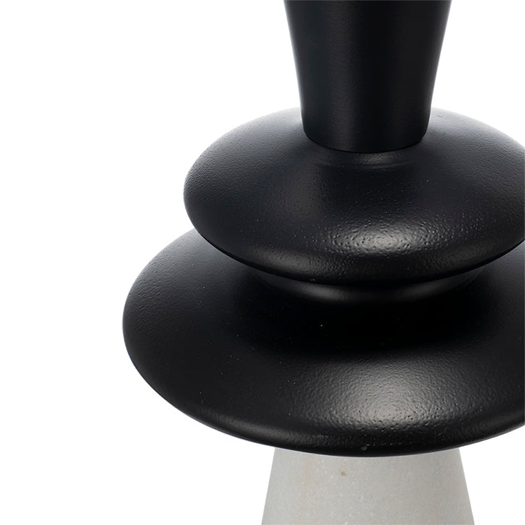 Close-up of a black base table lamp on a white background