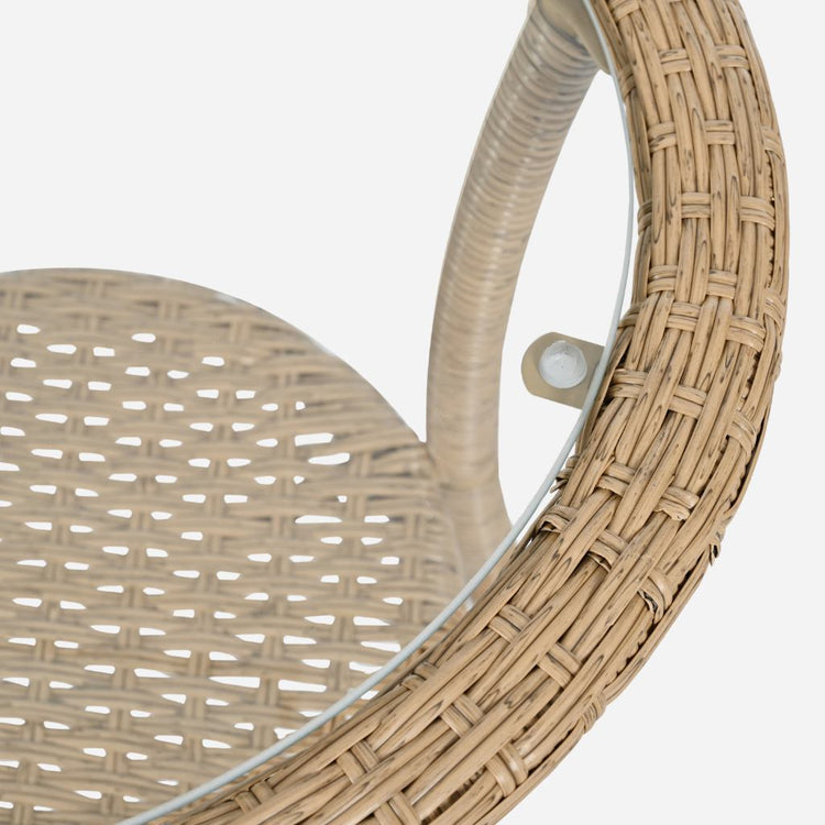 Close-up of a rattan chair with a clear glass top on a white background