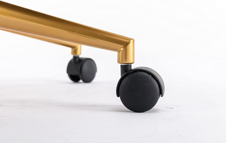 Close-up of black caster wheel on a gold metal base of a chair.
