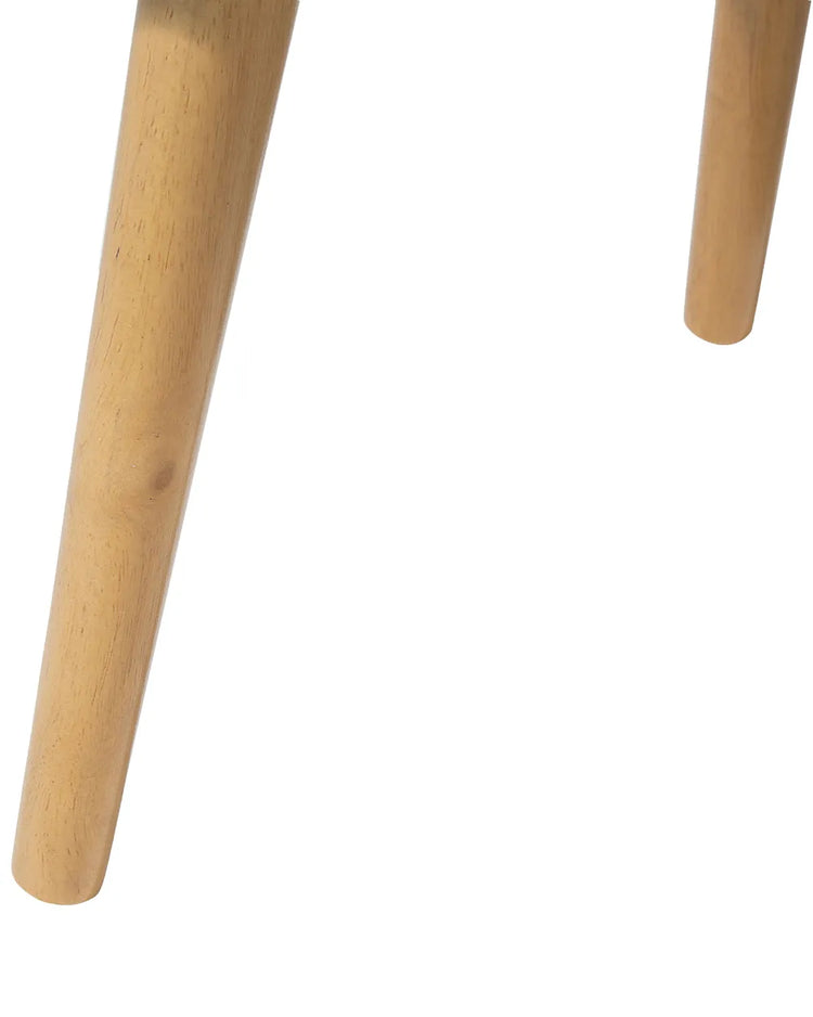 Two light wood tapered legs of a modern white piano finish end table.