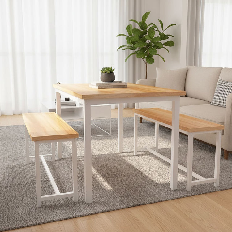 Compact counter-height dining set with white frames and natural wood tops, paired with benches in a bright living room.