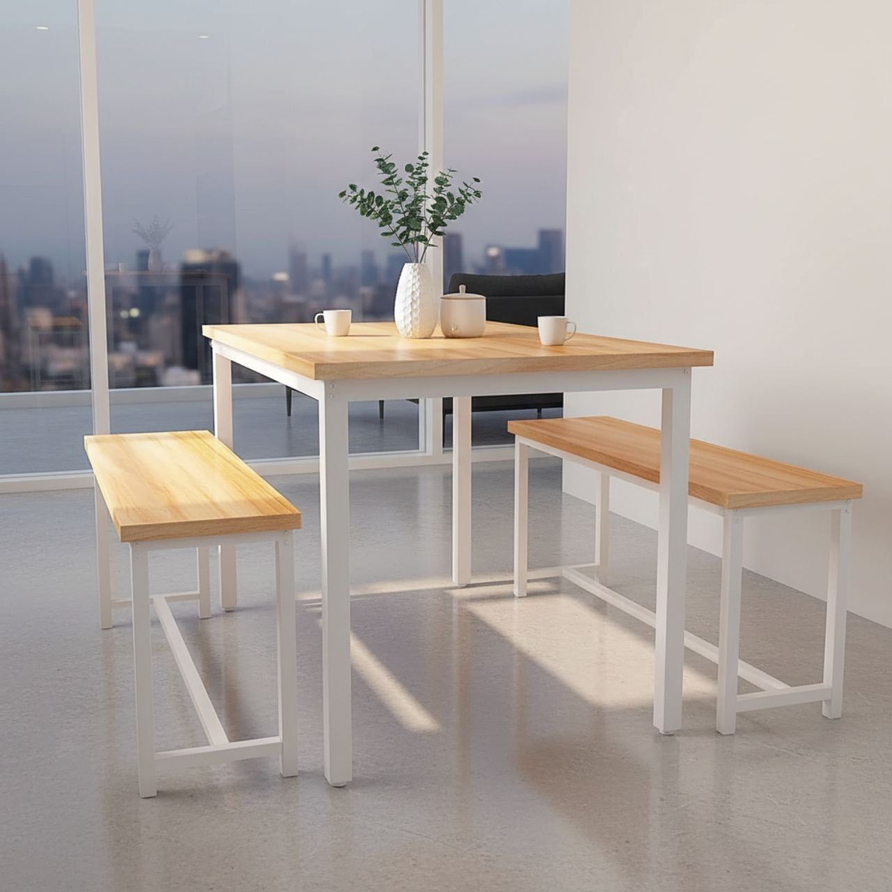 Compact counter-height dining table set in gold and white with matching benches in a bright city apartment.