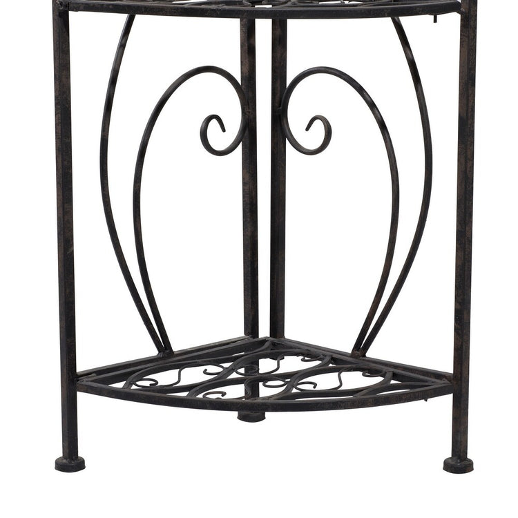 Decorative black metal plant stand with intricate designs on a white background