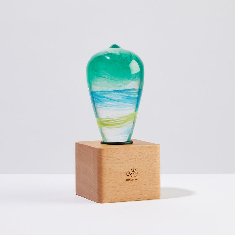 Decorative glass vase with a wooden base on a white background