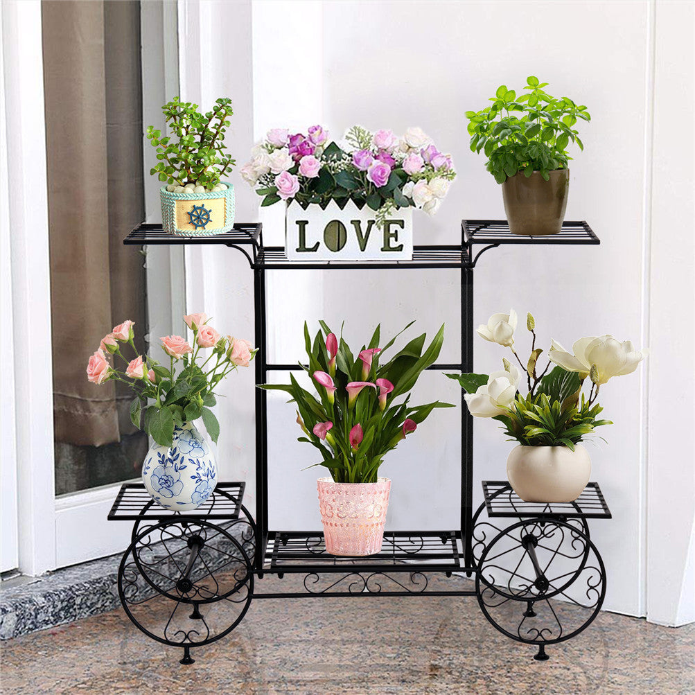 Durable six-tier garden cart plant holder on a wrought-iron stand with potted flowers on decorative wheels.