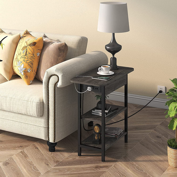 End table with flip-top left side housing charging station, USB ports, and two outlets beside a sofa with a lamp.