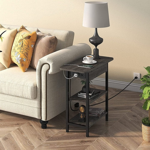 End table with left-side flip-top charging station, USB ports, and two outlets beside a sofa.