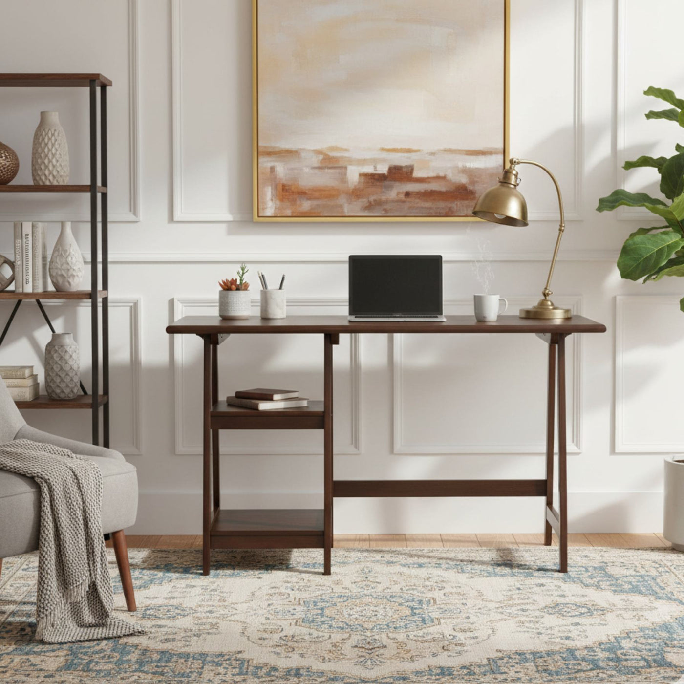 Espresso finish wood home office laptop desk with laptop, brass lamp, plant, and books.