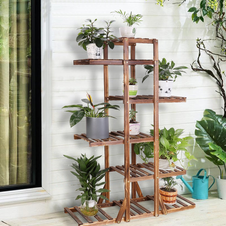 Indoor 6-tier wooden plant stand in solid pine with multiple potted plants on a vertical, space-saving display