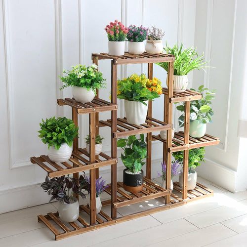 Indoor 9-Tier Wooden Plant Stand with lush potted greens; sturdy pine build, space-saving home decor for living rooms.
