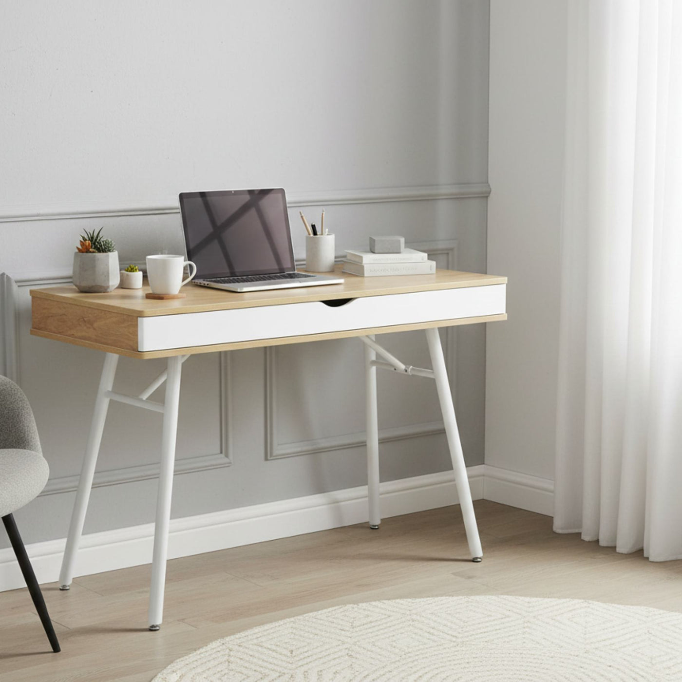 Laptop computer desk with storage drawer, pine wood finish top and white steel legs, compact workspace.