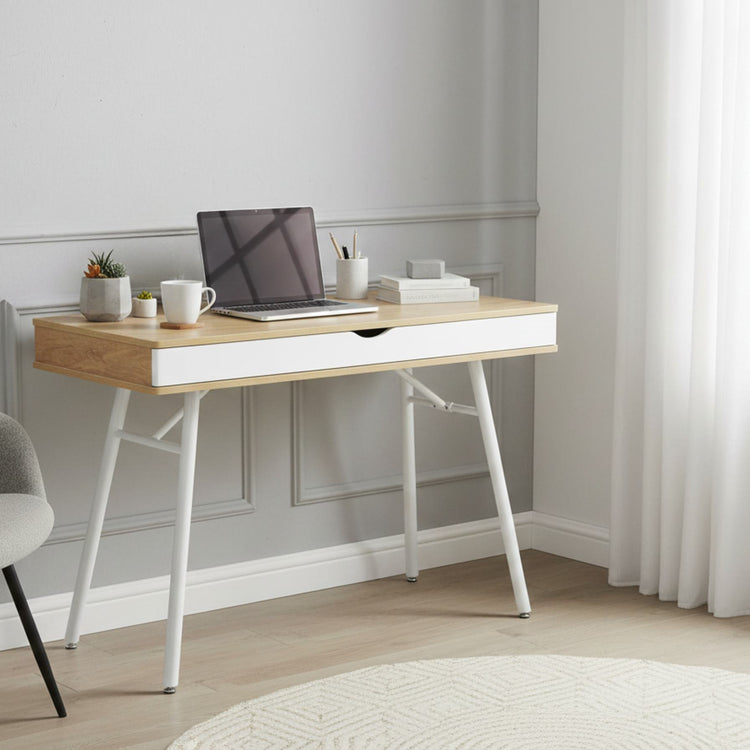 Laptop computer desk with storage drawer, pine wood finish top and white steel legs, compact workspace.