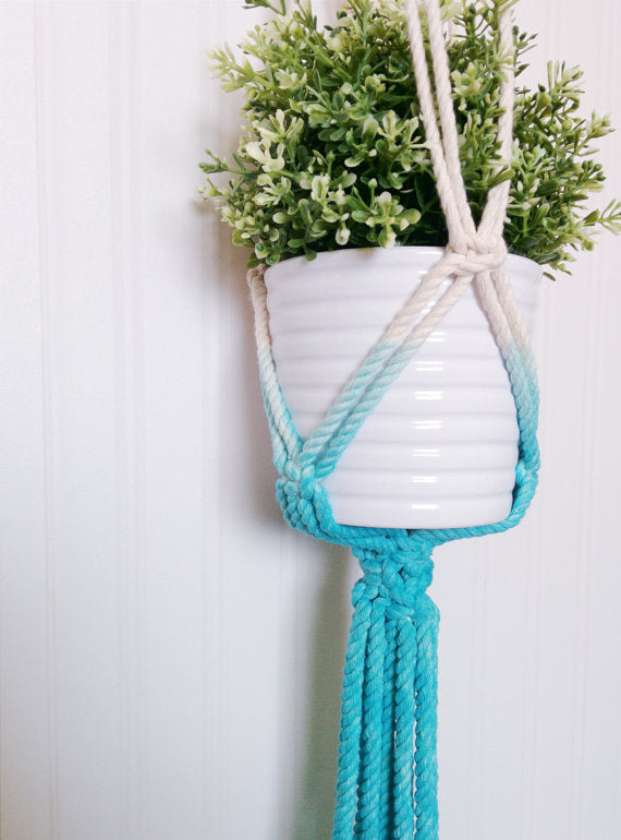 Macrame plant hanger dip-dye aquamarine, handmade in Canada, holding a green plant in a white pot