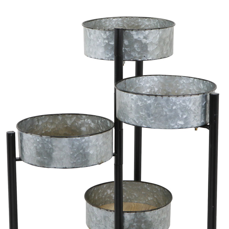 Metal plant stand with galvanized metal pots on a white background