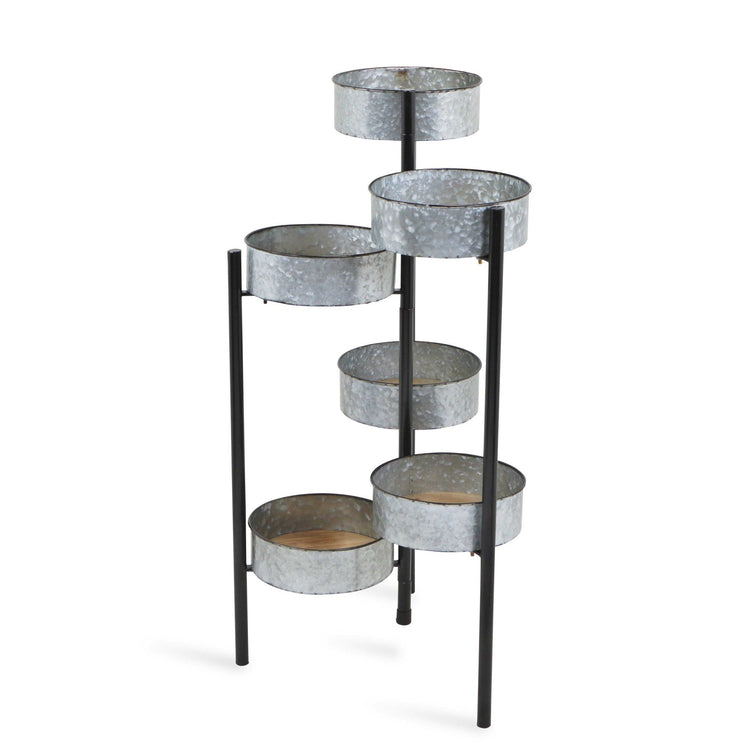 Metal plant stand with multiple circular shelves on a white background
