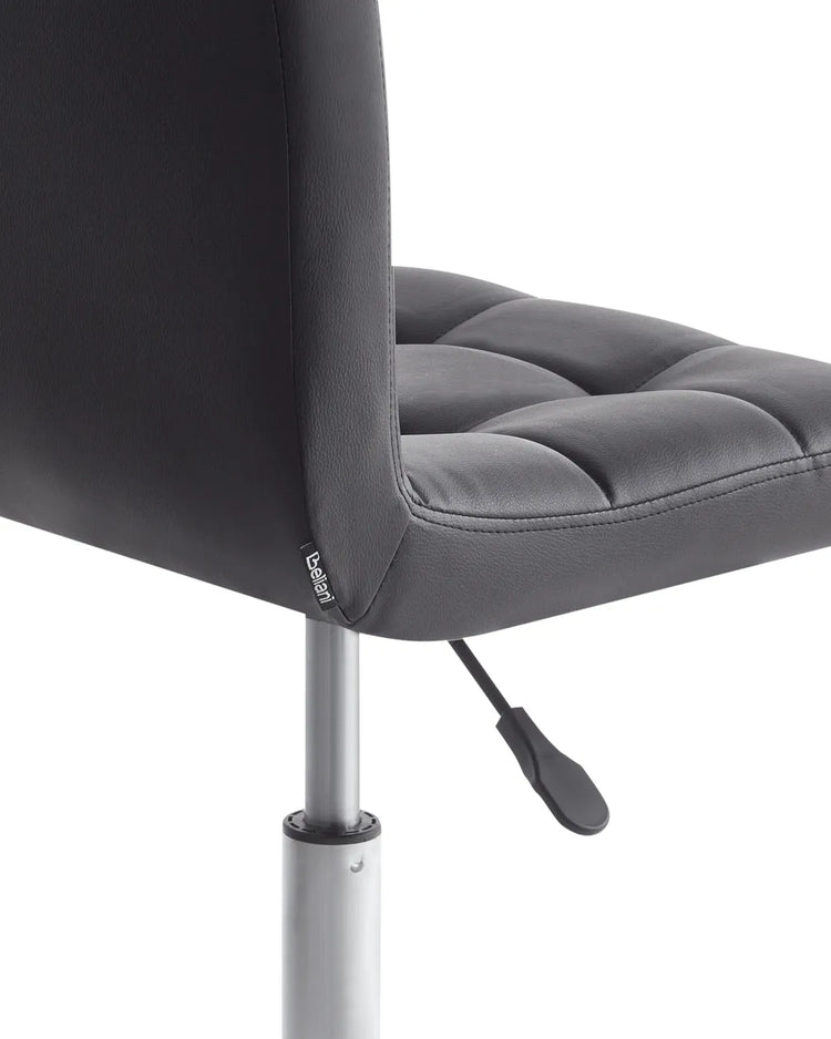 Modern black faux-leather cushion office chair with quilted seat and tilt lever on chrome pedestal base.