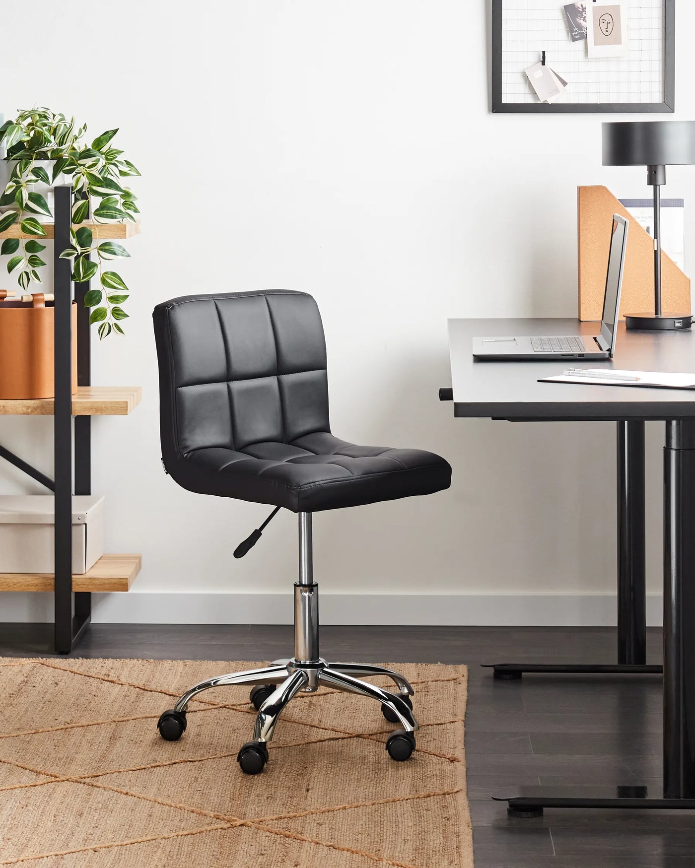 Modern black faux leather quilted chair with Bauhaus-inspired comfort for focused work in a minimalist home office.