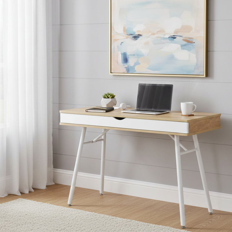 Modern style desk with pine wood finish and white storage drawer, white metal legs in a bright minimalist home office.