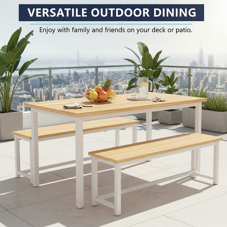 Outdoor dining set with table and benches on a deck with cityscape view.