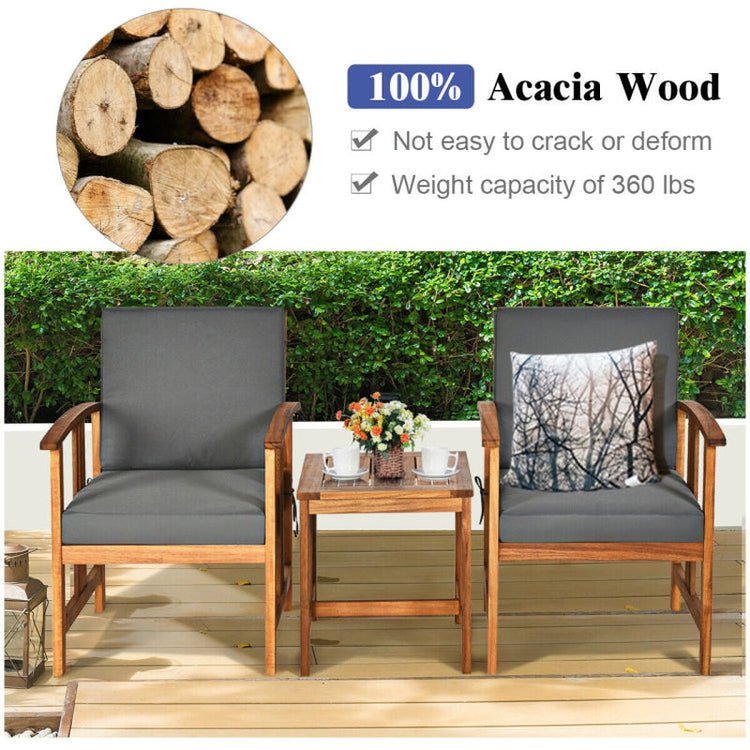 Outdoor furniture set with wooden chairs and table on a deck, featuring acacia wood logs.
