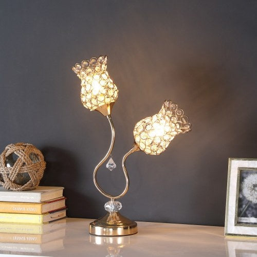 Decorative table lamp with crystal design on a surface against a dark background