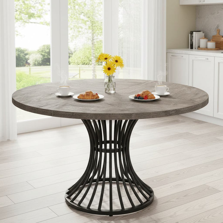 Round 47-inch grey dining table for kitchen and living room, seats 4-6, sculpted black base.