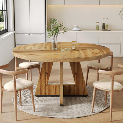 Round wooden dining table with chairs in a modern kitchen setting