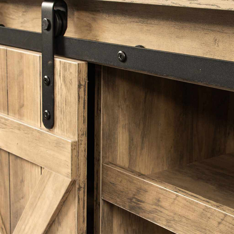 Rustic walnut-finish TV stand with sliding barn door and black metal rail, modern farmhouse style.
