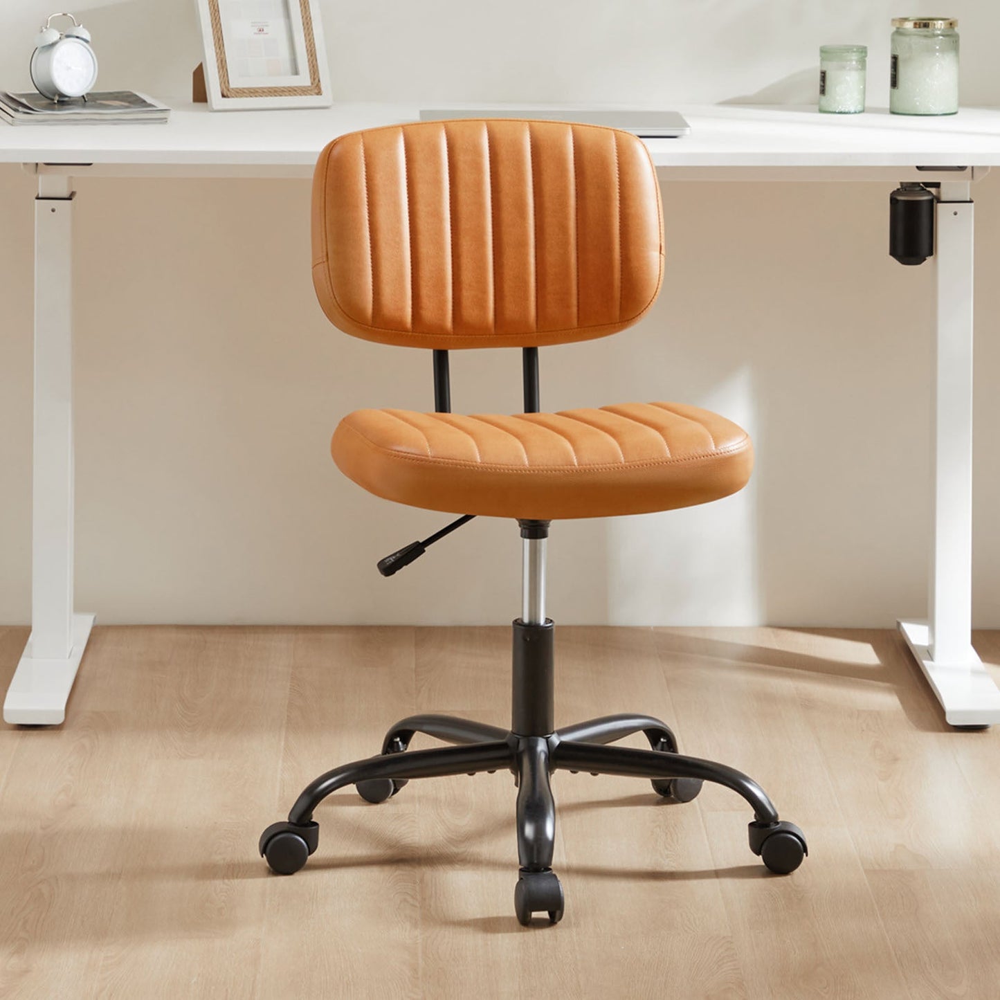 SWEETCRISPY PU Leather Low Back Task Chair with cushioned seat, vertical stitching, adjustable height, caster wheels.