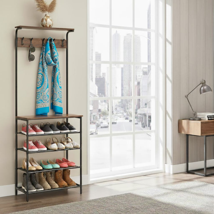 Shoe rack with shoes and a scarf in a room with large windows.