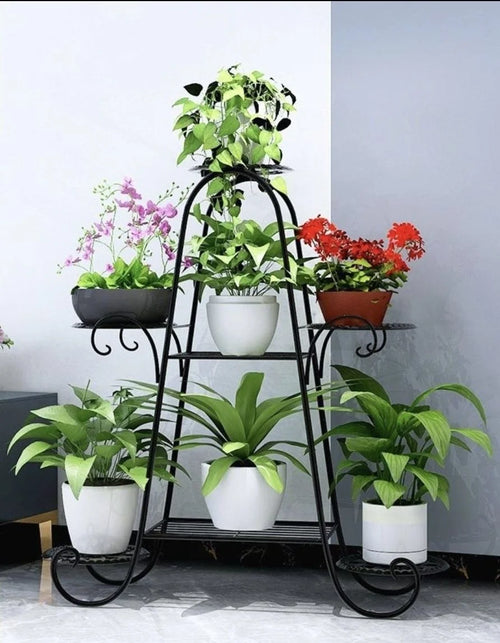 Six-tier black metal plant rack with pots on a curved stand, space-saving vertical garden display.