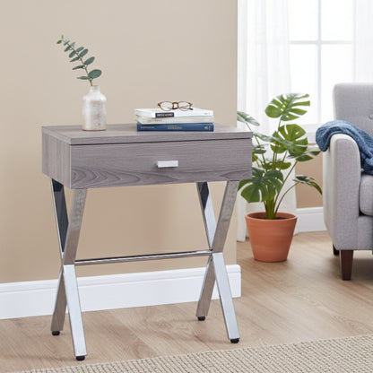 Dark taupe accent table with chrome legs, shown against a #f3f3f3 studio backdrop.
