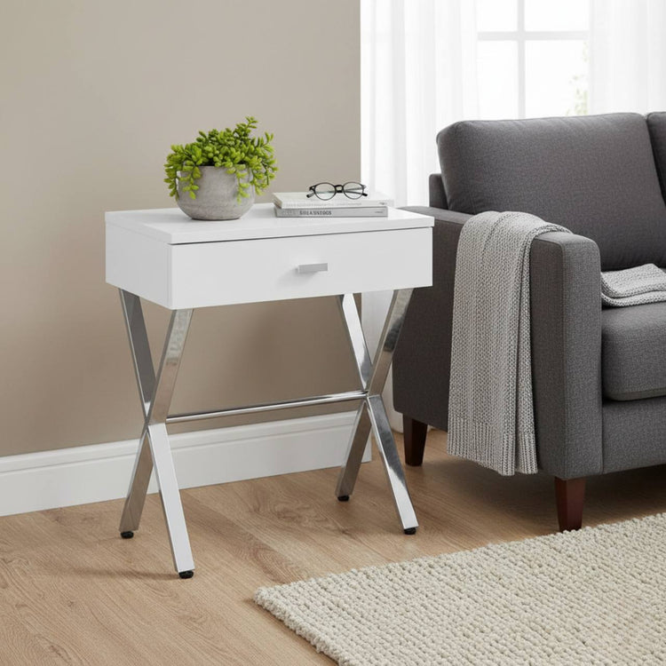 Sleek white Taupe Finish and Chrome Metal Accent Table beside a gray sofa, with a plant, books, and glasses.
