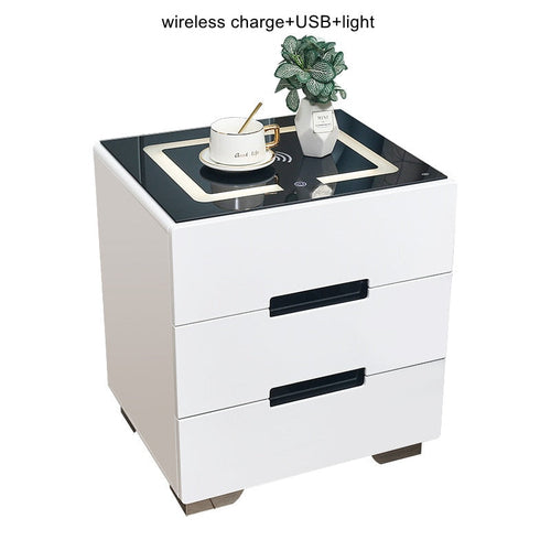 Smart bedside table with Qi wireless charging and USB ports, ambient night light, white 2-drawer unit with black top.