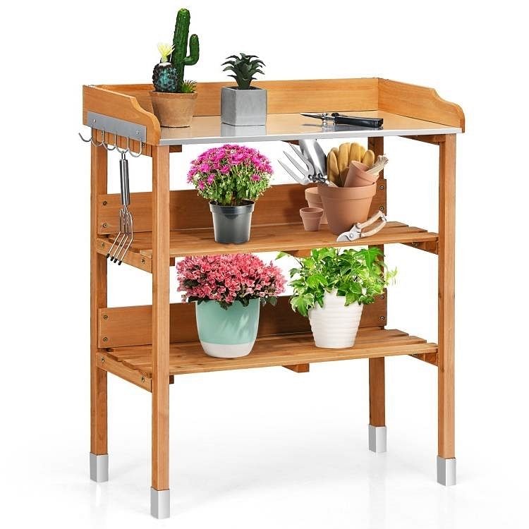 Solid wood outdoor garden bench table with bottom storage shelves and metal top, plus side hooks for tools.