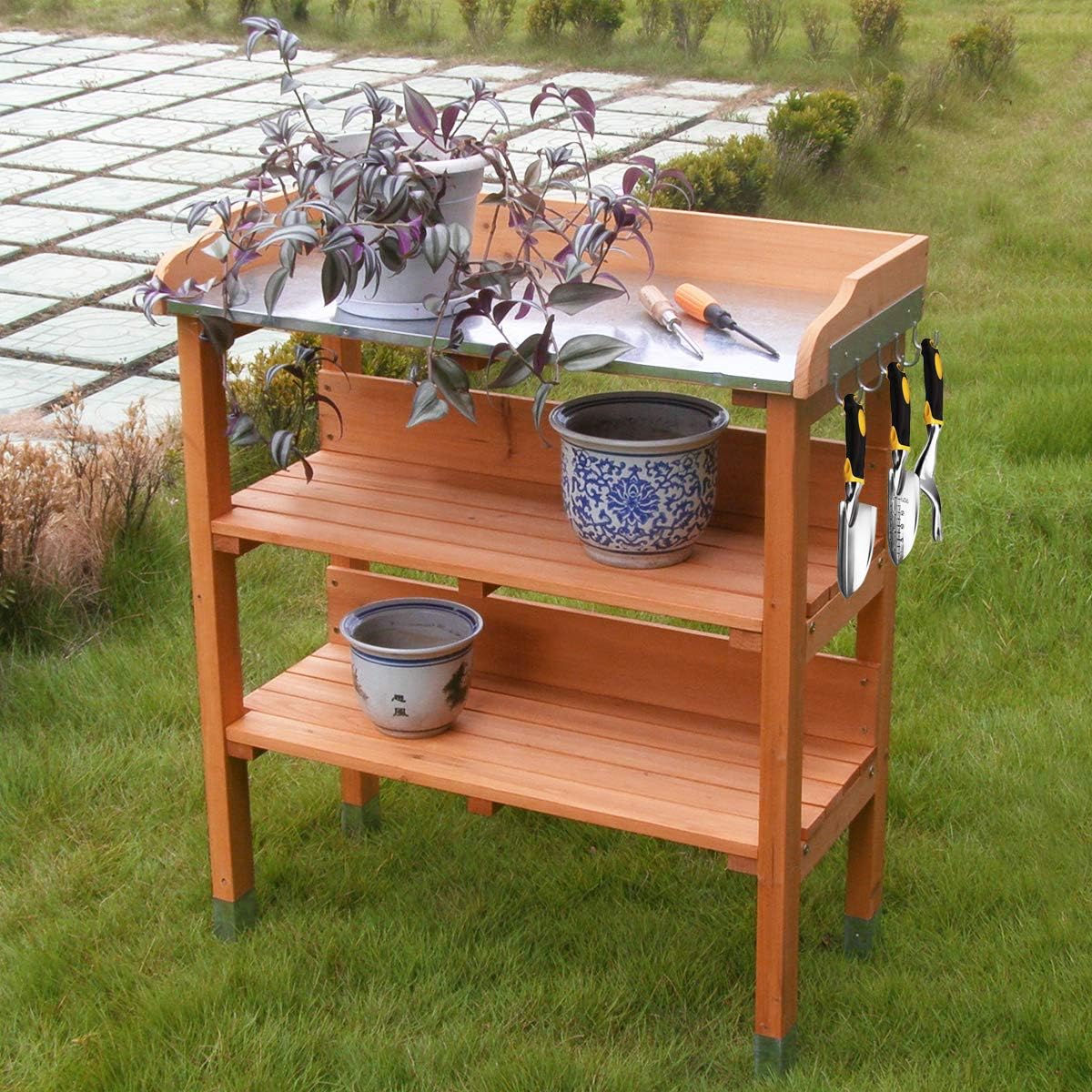 Solid wood outdoor garden bench table with metal top, bottom storage shelves, and side tool hooks.