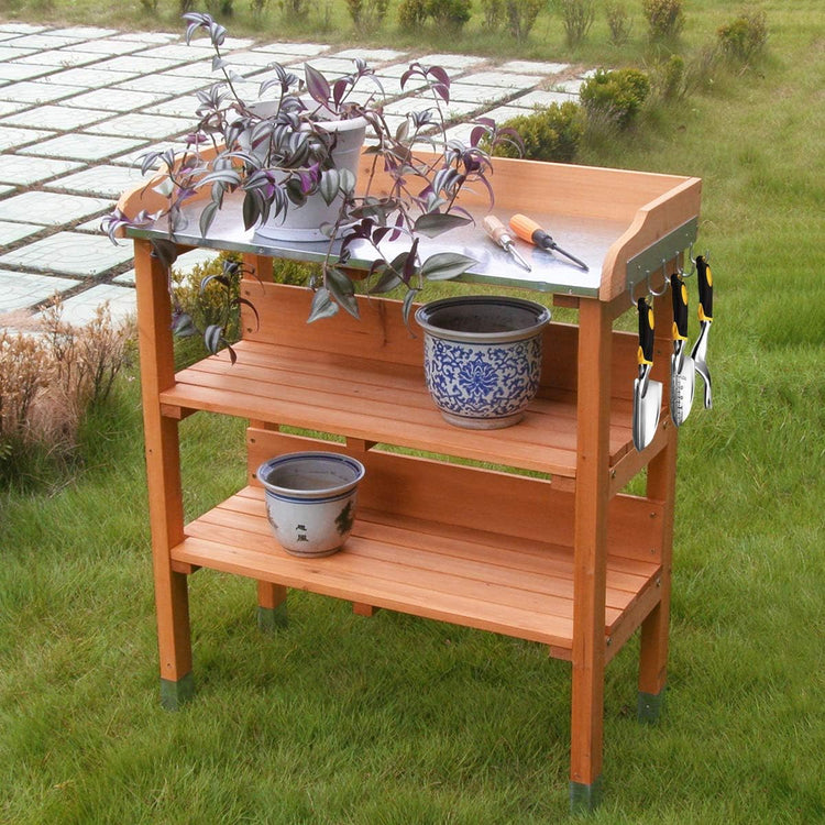 Solid wood outdoor garden bench table with metal top, bottom storage shelves, and side tool hooks.