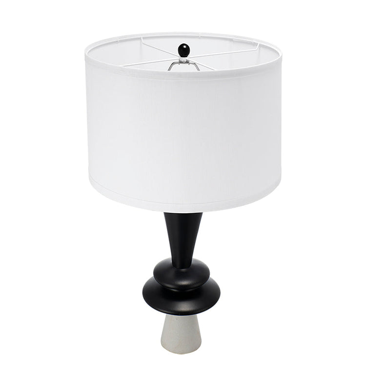 Table lamp with white shade and black base on a white background