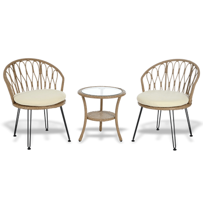 Two wicker chairs with cream cushions and a matching side table on a white background