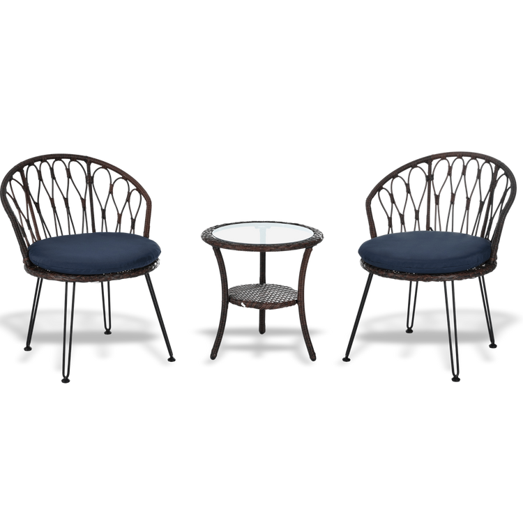 Two wicker chairs with navy cushions and a matching side table on a white background