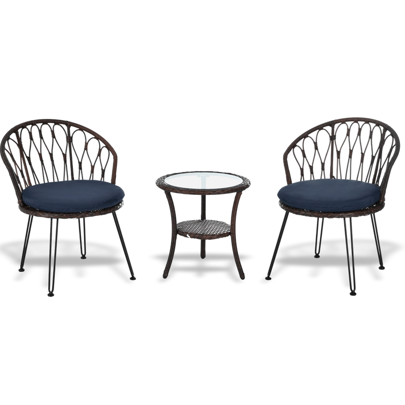 Two wicker chairs with navy cushions and a matching side table on a white background