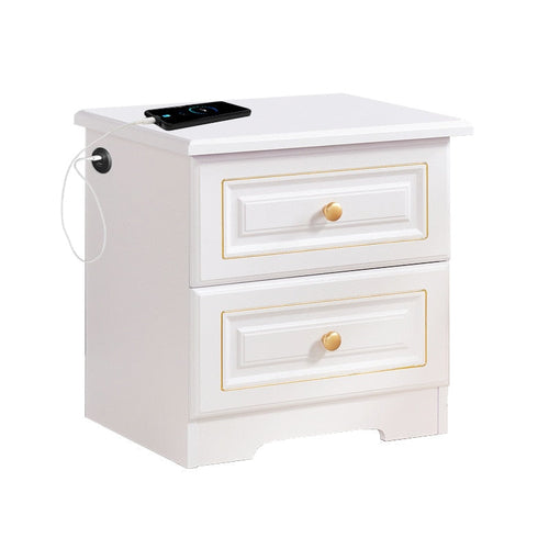 White two-drawer bedside table with Qi wireless charging pad on top and USB ports.