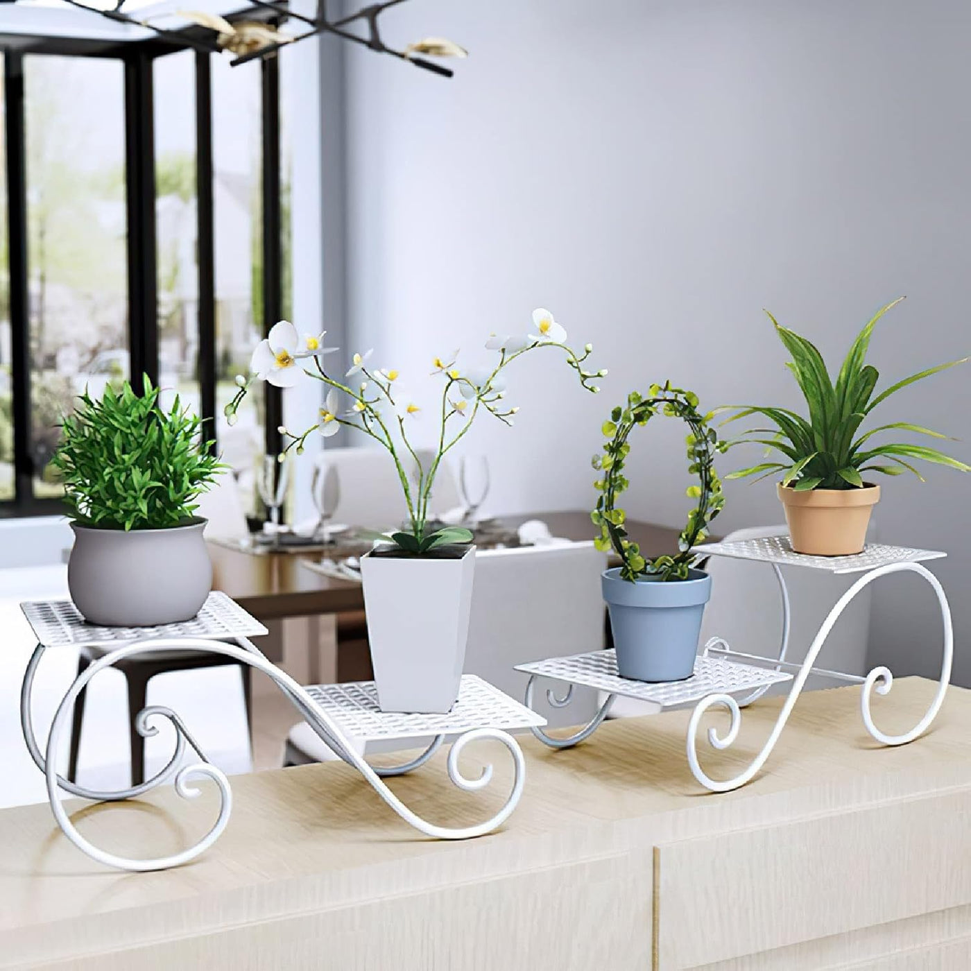 White wrought-iron six-tier plant stand for vertical display with potted plants on a counter by a window.