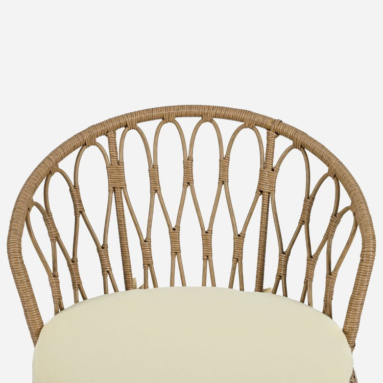 Wicker chair with a cream cushion on a white background